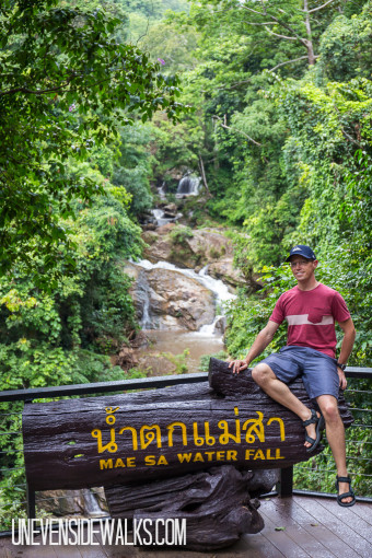 Landon Posing Next to the Mae Sa Waterfalls and Sign